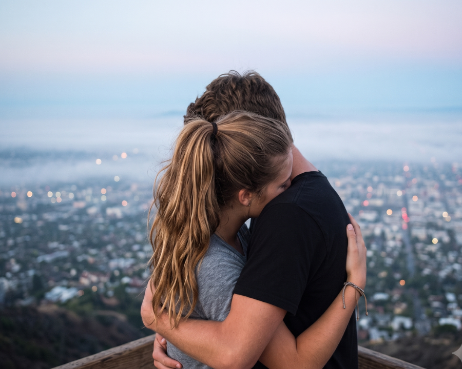 couple hugging tight on a place overviewing the city and the mist, Moving Toward Earned Security Together in Relationship attachment style