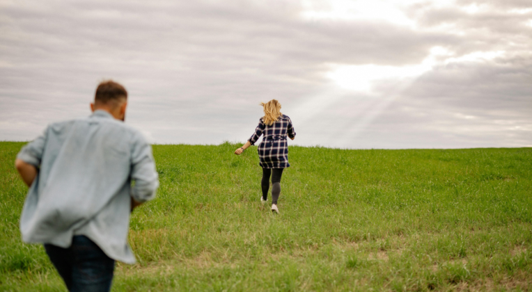 couple chasing each other through the hill, relationship attachment style